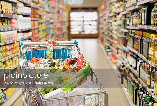 Close up of full shopping cart in grocery store