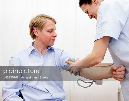 Doctor patient taking blood pressure