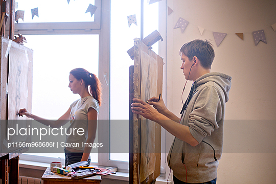 Two Art Students Drawing a Live Model