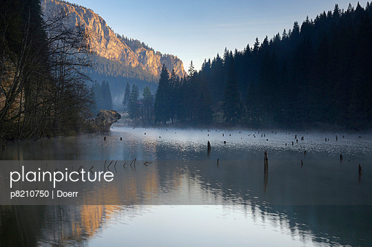 Red Lake and Suhardul Mara-massif (1,507m) with reflections and tree stumps sticking out of water, Cheile Bicazului-Hasmas National Park, Carpathian, Transsylvania, Romania, October 2008