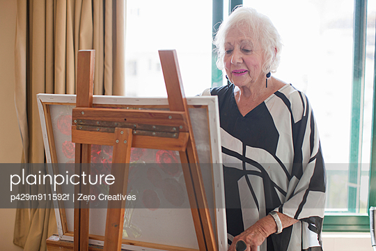 Senior women painting art canvas in retirement villa