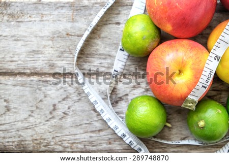 Healthy Fruit with measuring tape on wooden top , for lose weight ,Diet , still life background, Healthy lifestyle concept