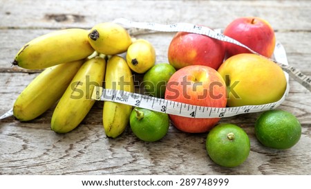 Healthy Fruit with measuring tape on wooden top , for lose weight ,Diet, Healthy lifestyle concept