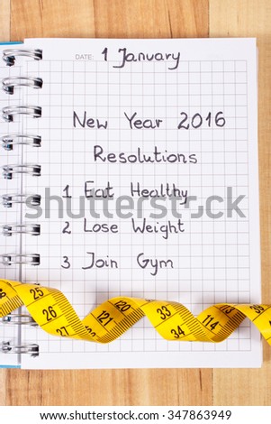 New years resolutions eat healthy, lose weight and join gym written in notebook and tape measure, concept of healthy lifestyle