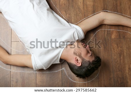 Crime scene simulation, young man lying on floor