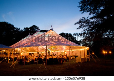 Wedding tent at night - Special event tent lit up from the inside with dark blue night time sky and trees