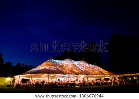 Wedding tent at night - Special event tent lit up from the inside with dark blue night time sky and trees