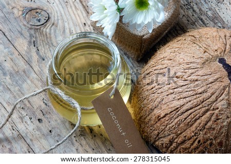 Coconut oil, essential oil from nature, a skin care that safe, rich vitamin, use in massage at spa, organic cosmetic on wooden background