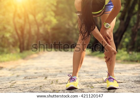 woman runner hold her sports injured knee