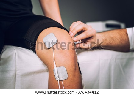 TENS electrodes positioned for knee pain treatment in physical therapy