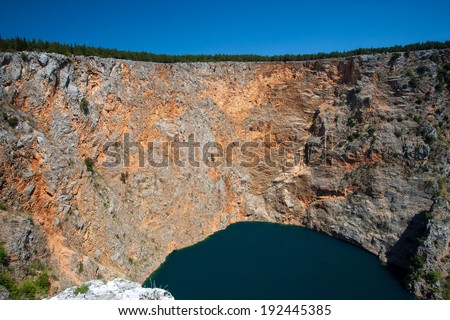 IMOTSKI, CROATIA - April 24, 2013 - Red lake in Imotski, Croatia is a limestone crater, with it\'s cliffs 200 m high and lake 300 m deep.