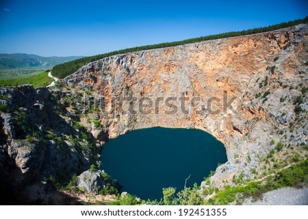 IMOTSKI, CROATIA - April 24, 2013 - Red lake in Imotski, Croatia is a limestone crater, with it\'s cliffs 200 m high and lake 300 m deep.