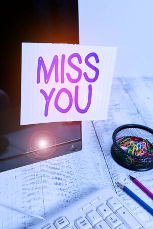 Conceptual hand writing showing Miss You. Concept meaning Feeling sad because you are not here anymore loving message Note paper taped to black screen near keyboard stationary