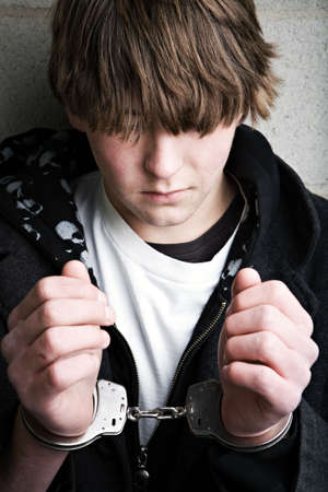 teen male portrait wearing handcuffs