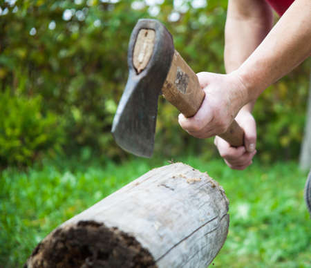 Chopping firewood in the open air.