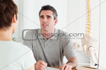 Doctor and patient sitting at a table talking