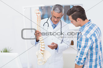 Doctor explaining the spine to his patient