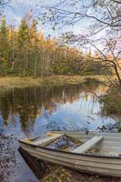 Half sunken rowing boat near the cabin