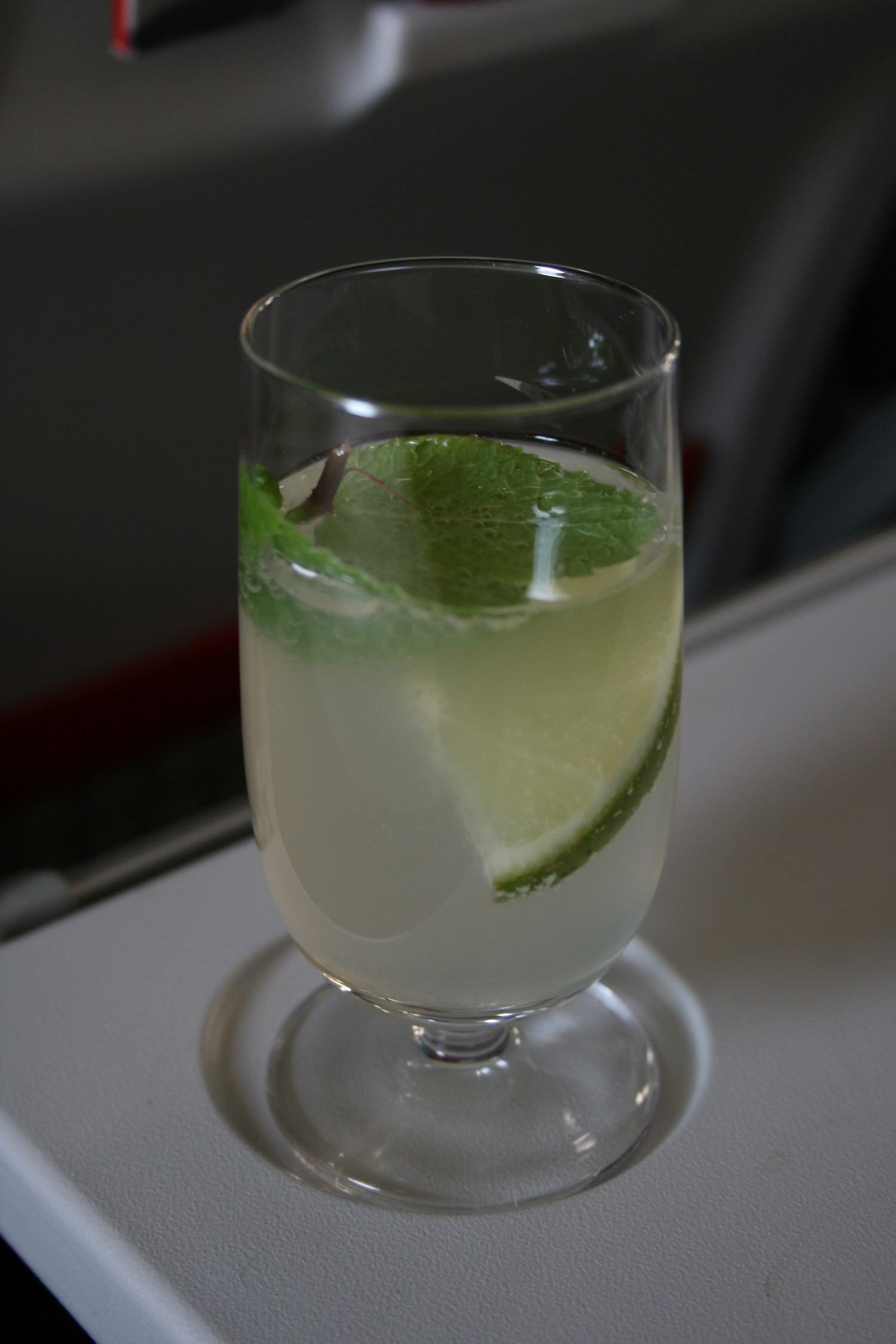 a glass with a drink and a slice of lime