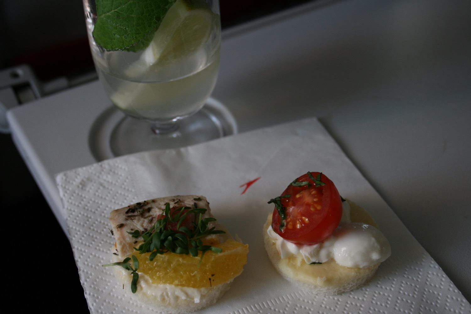 food on a napkin next to a glass of water