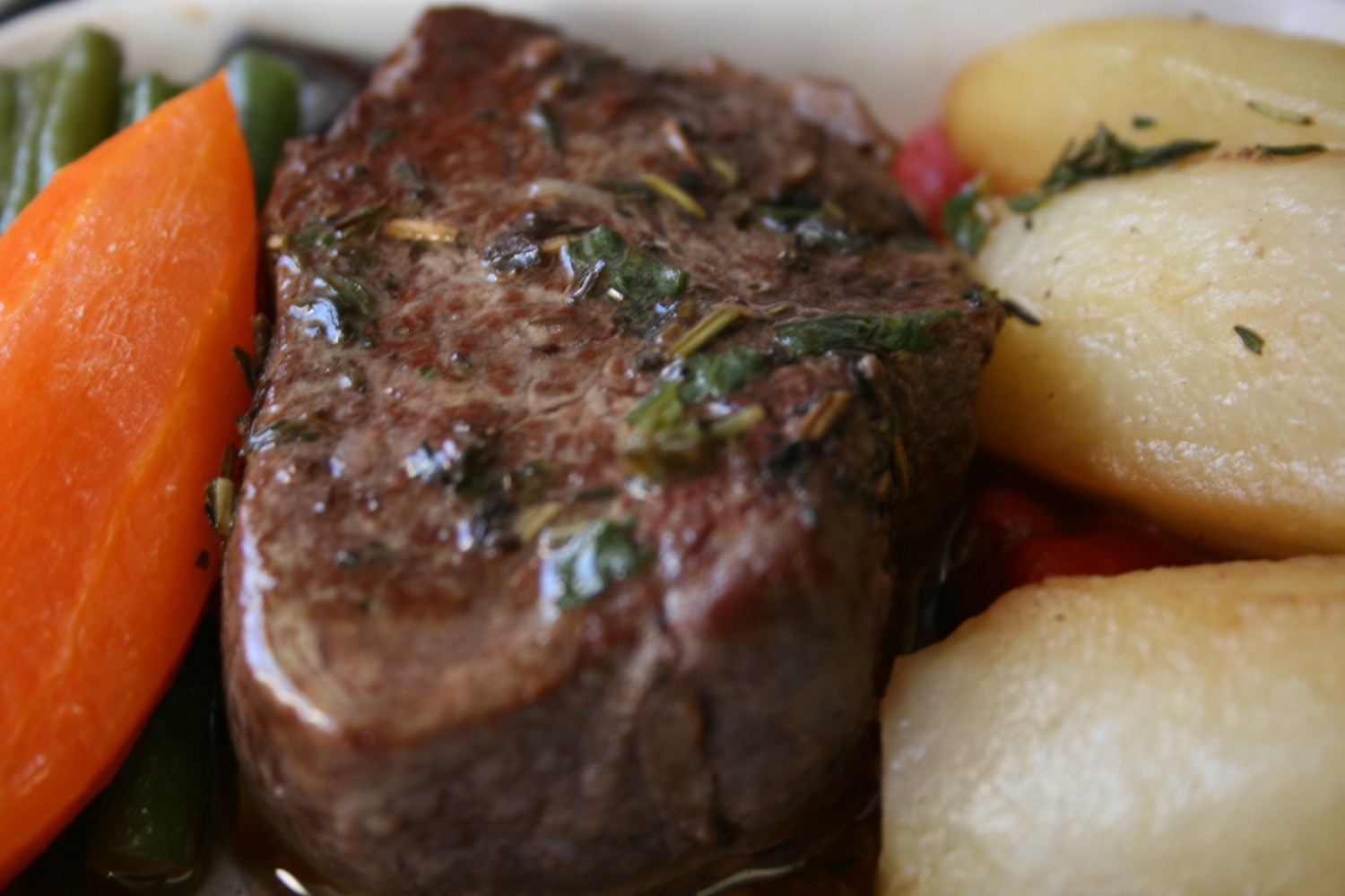 a plate of food with meat and vegetables