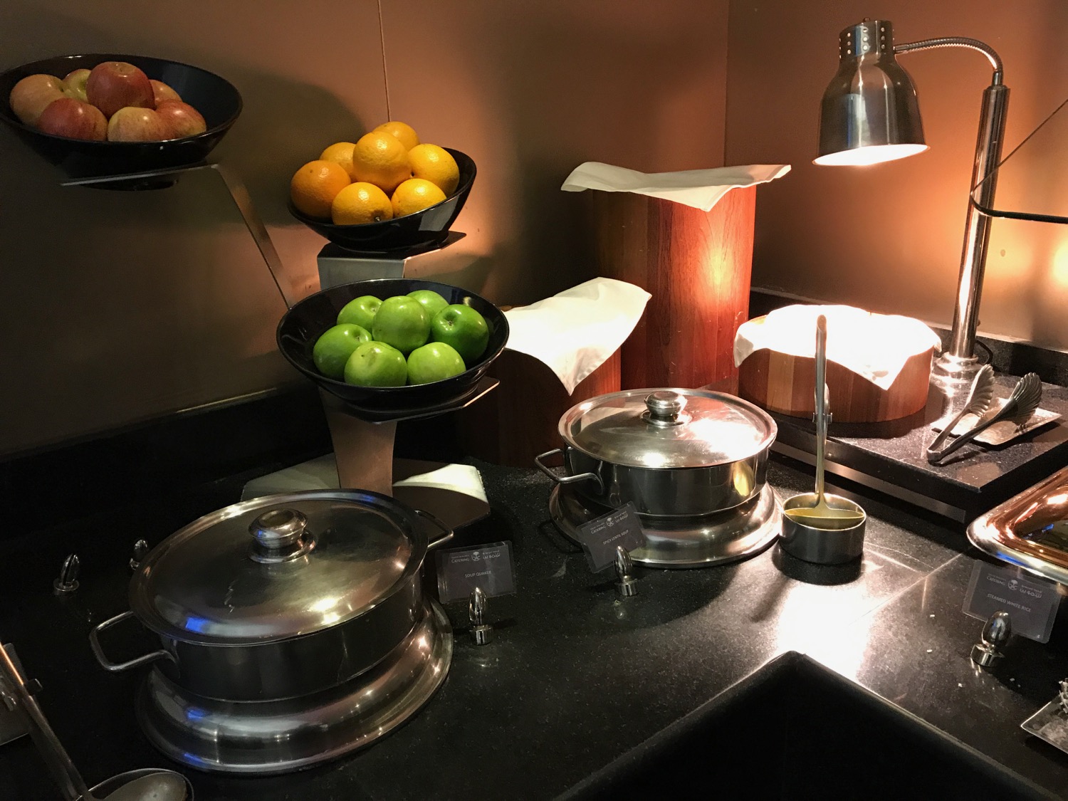 a kitchen counter with fruit and sauces