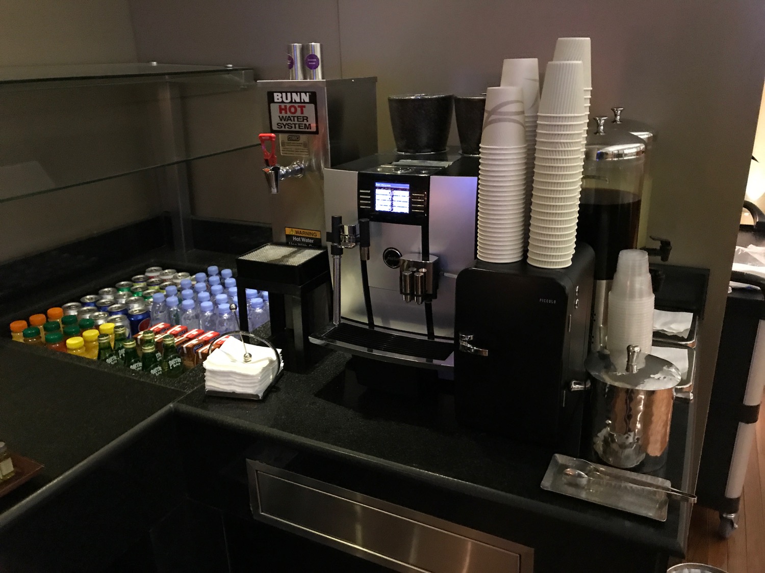 a coffee machine and cups on a counter