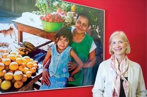 Pro Mujer cofounder Lynne Patterson stands next to a photo mural in the Latin American microlender's New York headquarters.