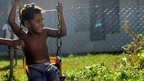 Children play on a swing in Vanuatu