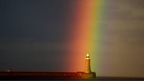 A rainbow appears over the lighthouse at Tynemouth