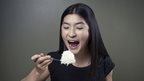 woman eating rice