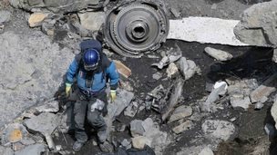 French rescue worker inspects debris near Seyne-les-Alpes