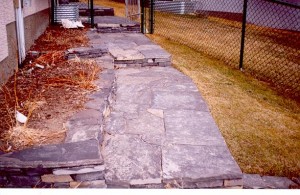 Stepped Up Rundle Stone Sidewalk beside Rundle Stone Raised Flower Bed