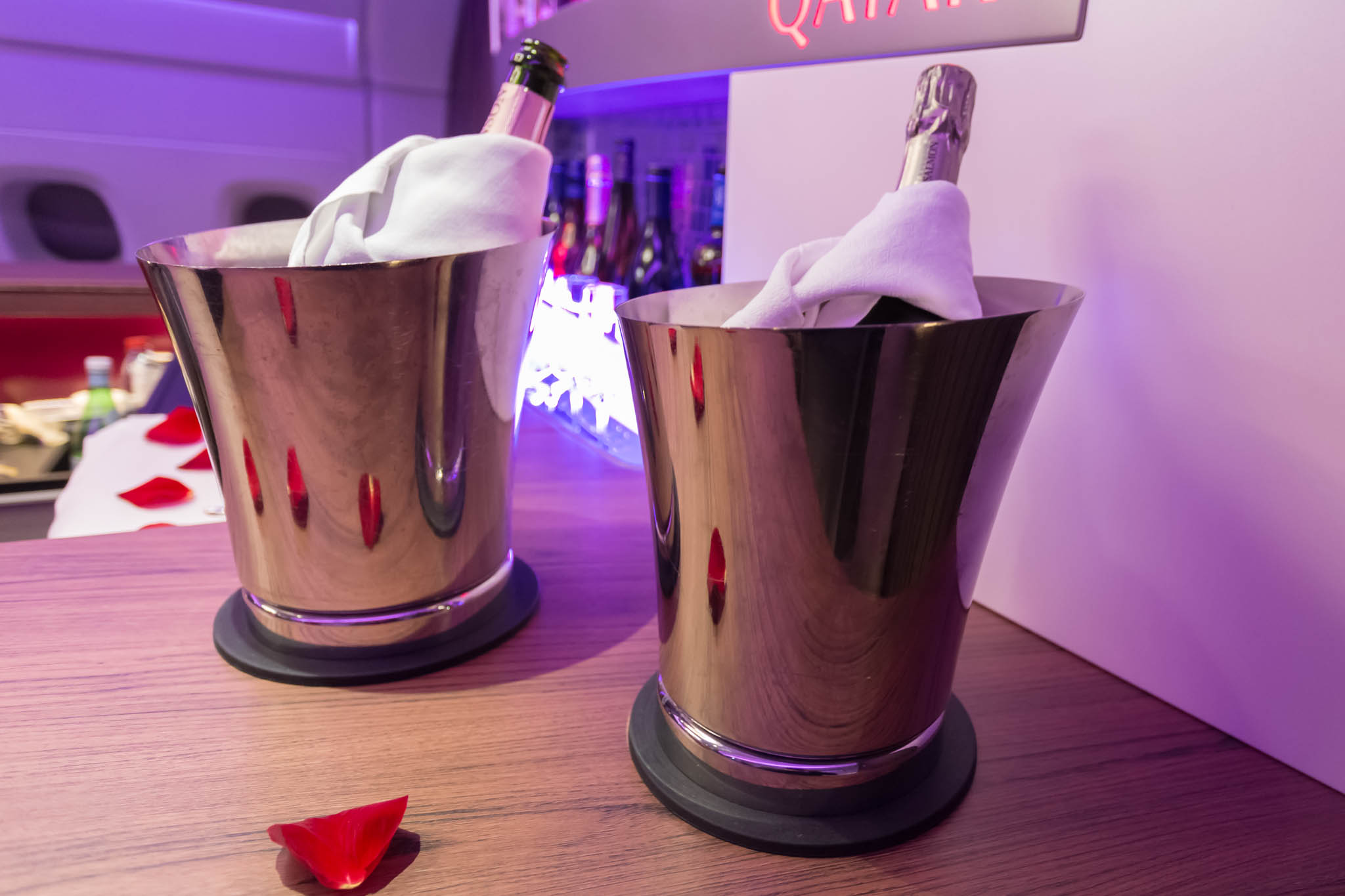 two silver buckets with bottles of wine