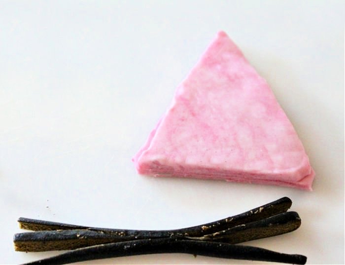 Pink fondant and black licorice for adding facial features to a Black Cat Cake for Halloween