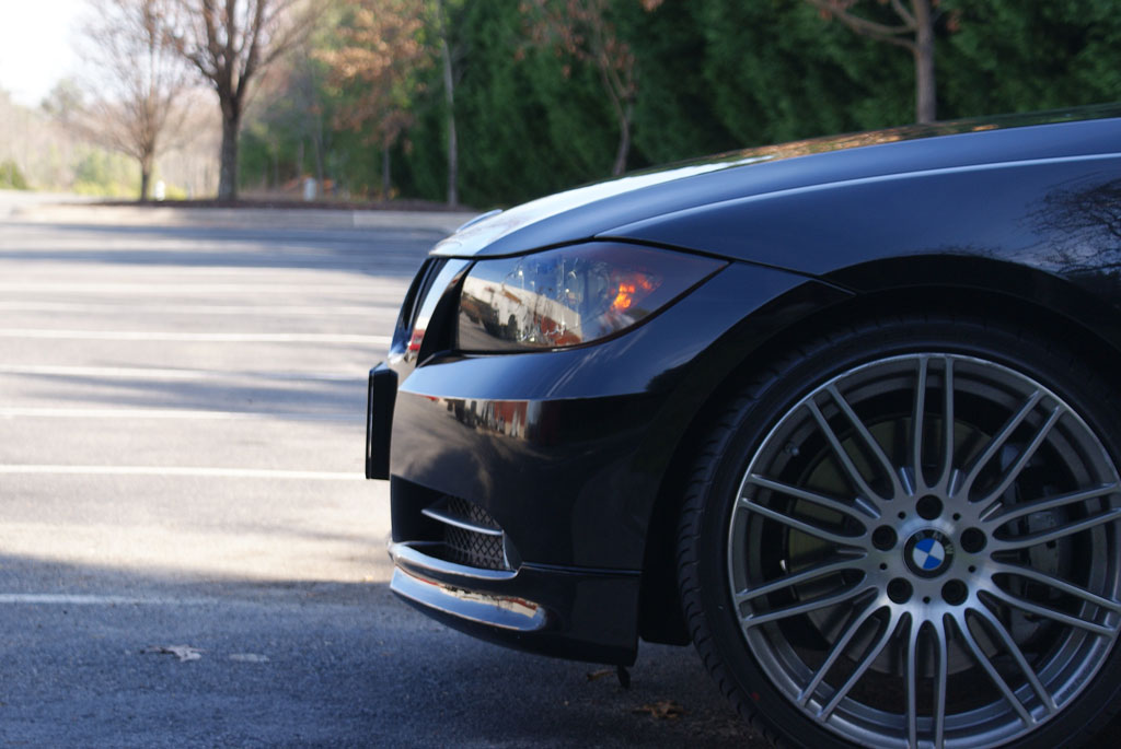 Black BMW with tinted headlights