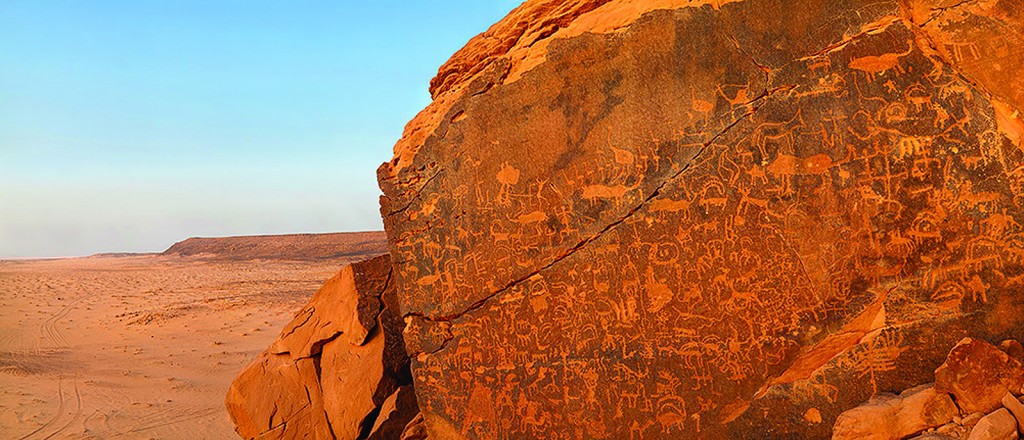 Qaryat al Asba petroglyph panel, in Riyadh Province, with the Najd in the background.