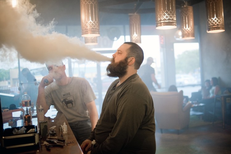 Caswell Posey tests his e-cigarette device prior to the Clouds for Heroes vape competition.