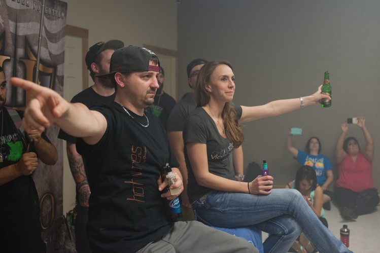 Judges Matt Maynard, left, and Amie Love, right, give their vote for winners in a round of the competition. Mr. Maynard and Ms. Love work at separate vape shops in the Dallas area.