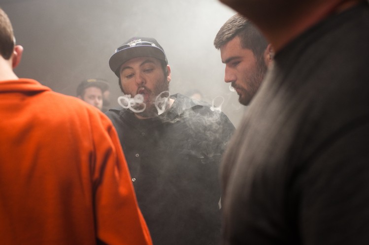 Alex Bullock blows vapor rings among a crowd of participants. E-cigarettes first arrived in the U.S. about eight years ago, but it wasn’t until two years ago, when vape shops took off, that shopkeepers started hosting contests to attract customers. Now, there are an estimated 8,500 vape shops in the U.S.