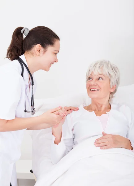 Happy Doctor And Patient Looking At Each Other