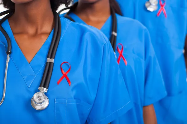 African medical doctors with red ribbon