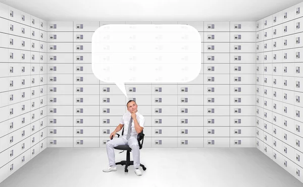 Businessman sitting in security safe room