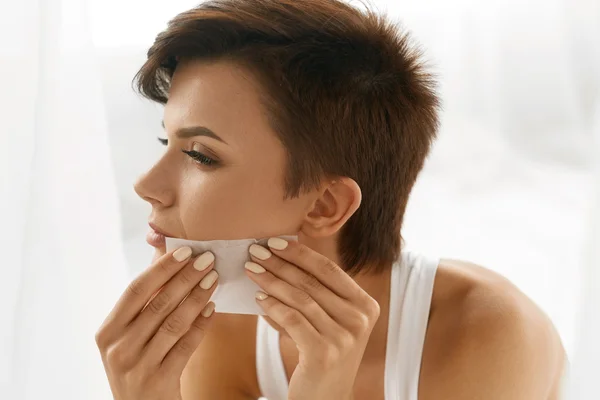 Skin Care. Woman Cleaning Face With Oil Absorbing Papers.