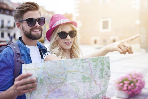 Couple using paper map in the city