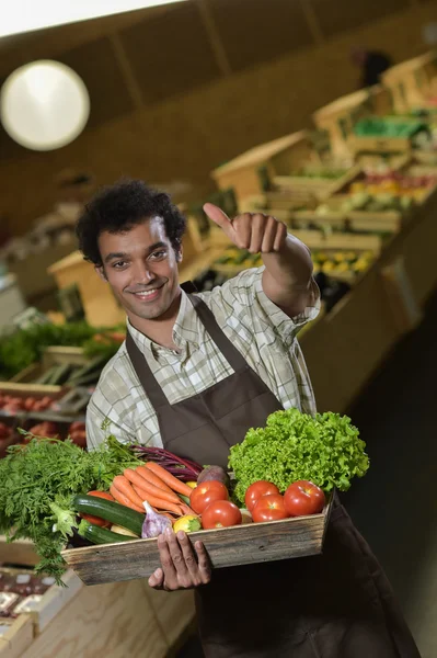 Grocery clerk working in produce aisle of supermarket store