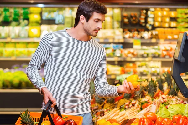 Man holding pepper and shopping bag