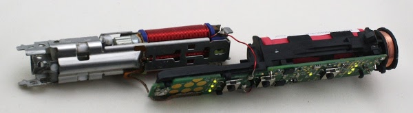 The brush mechanism (left) separated from the electronics (right). Note the illuminated LEDs. Alto note the flexible brown ribbon connecting the pressure sensor to the electronics board.