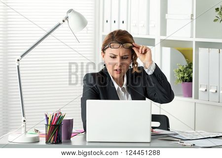 Portrait Of Surprised Businesswoman Looking At Laptop Screen