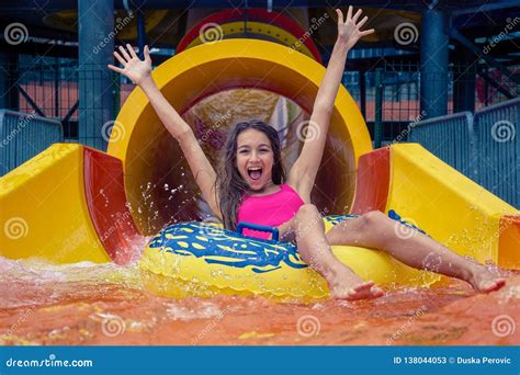 Girl in Aqua Park Have Fun Riding on Water Slide with Inflatable Ring ...